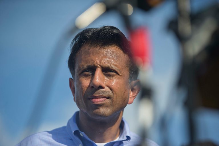 Louisiana Gov. Bobby Jindal, center, delivers a statement following a deadly shooting at the Grand 16 theater, Friday, July 24, 2015, in Lafayette, La. (AP Photo/Brynn Anderson)