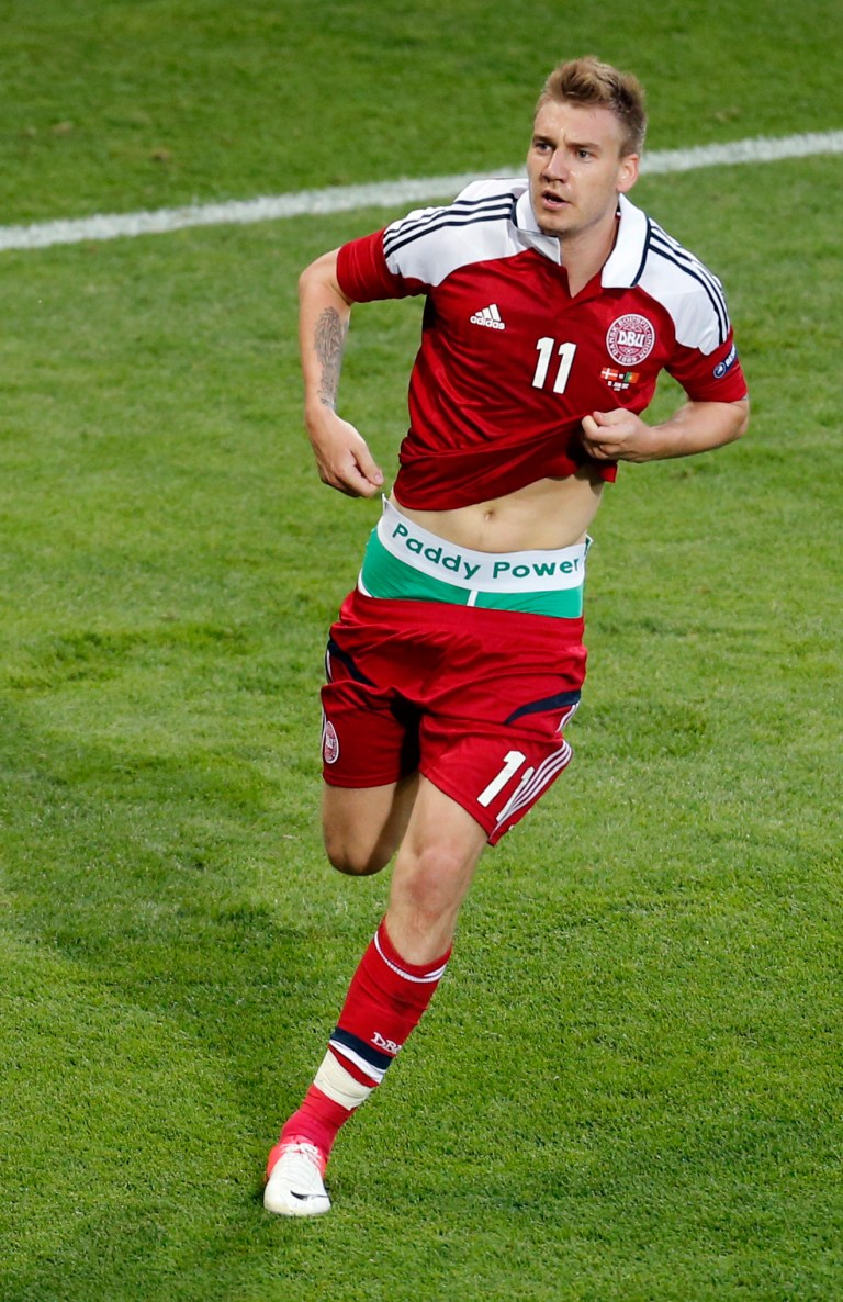   Denmark's Nicklas Bendtner shows his underpants with the writing 'Paddy Power' as he celebrates scoring his side's second goal during the Euro 2012 soccer championship Group B match between Denmark and Portugal in Lviv, Ukraine, Wednesday, June 13, 2012. (AP Photo/Michael Probst)  