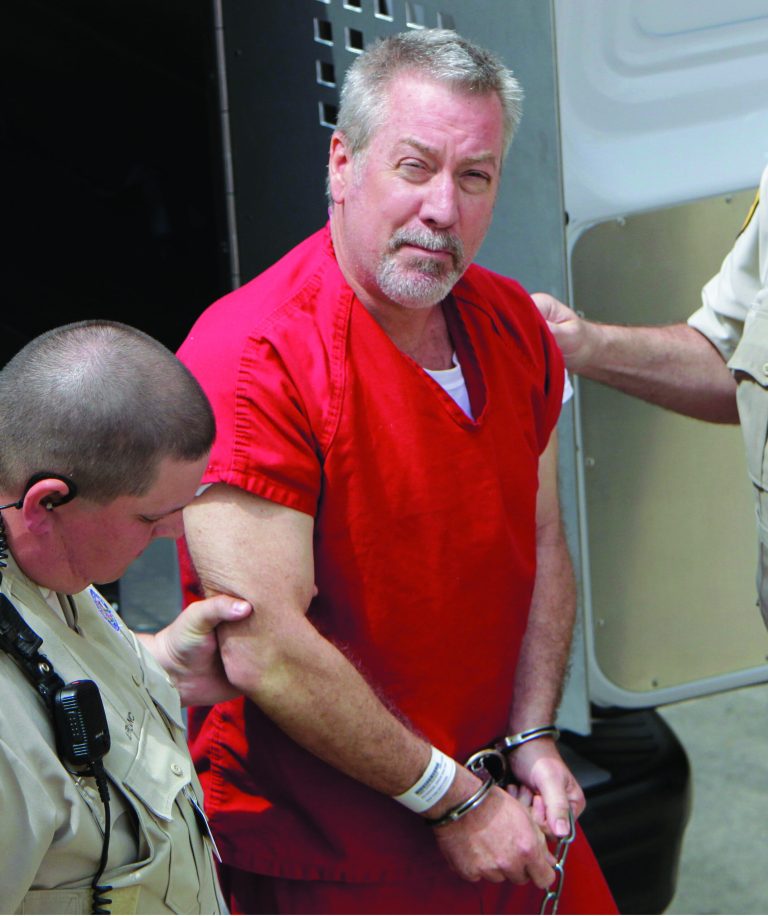 FILE - In this May 8, 2009 file photo, former Bolingbrook, Ill., police officer Drew Peterson arrives at the Will County Courthouse in Joliet, Ill., Friday, May 8, 2009, for his arraignment on charges of first-degree murder in the 2004 death of his former wife Kathleen Savio. Opening statements in Peterson's trial are scheduled to begin Tuesday, July 31, 2012. (AP Photo/M. Spencer Green, File)