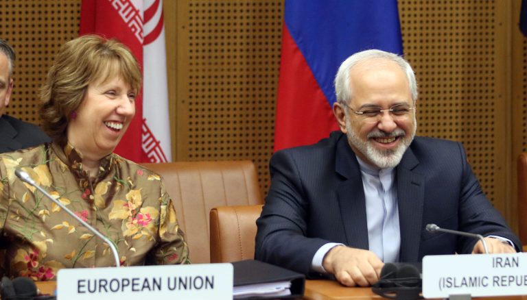 European foreign policy chief Catherine Ashton, left, and Iranian Foreign Minister Mohamad Javad Zarif, right, wait for the start of closed-door nuclear talks in Vienna, Austria, Wednesday, May 14, 2014. The talks between Iran and six world powers have entered an ambitious new stage with the two sides sitting down to start drafting the text of a final deal. (AP Photo/Ronald Zak)
