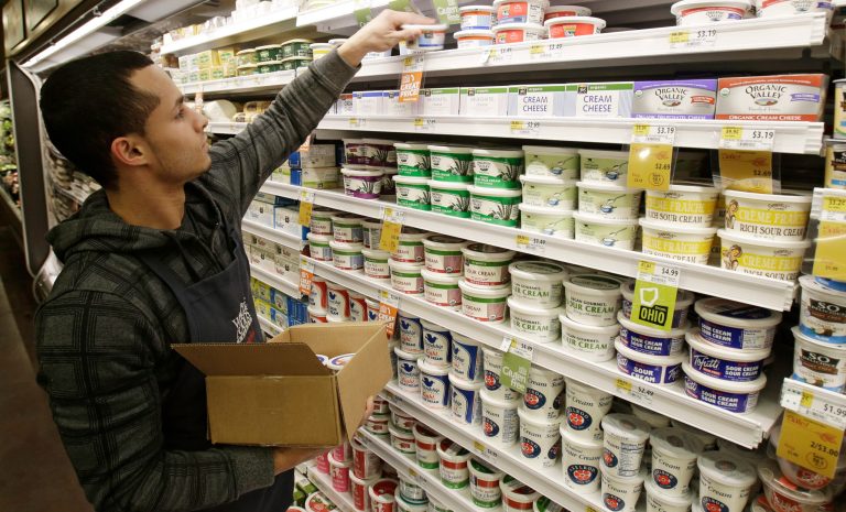 In this Thursday, March 27, 2014 photo, Christopher Quinones re-stocks cream cheese on a shelf at the Whole Foods Market in Woodmere Village, Ohio. The Labor Department releases Consumer Price Index for April on Thursday, May 15, 2014. (AP Photo/Tony Dejak)