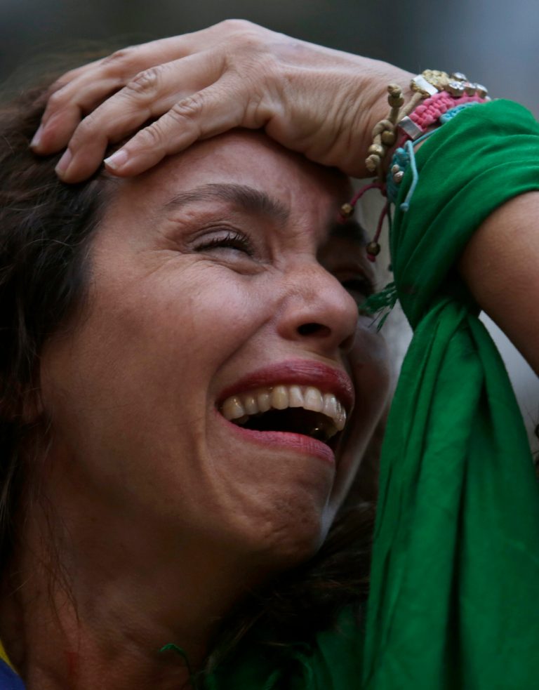 RETRANSMITTING FOR IMPROVED QUALITY.- A Brazil soccer fan cries as she watches Germany defeat her team in a World Cup semifinal match, via a live telecast in Belo Horizonte, Brazil, Tuesday, July 8, 2014. The tears started flowing before half time, and by the end of a 7-1 shellacking in the World Cup semifinal, millions across Brazil were in dazed, damp-eyed disbelief. (AP Photo/Bruno Magalhaes)