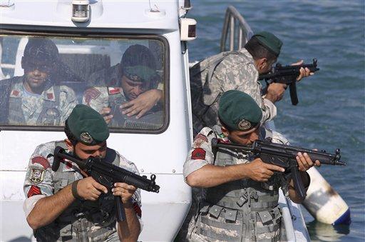 Iranian navy members take positions during a drill in the Sea of Oman, Wednesday, Dec. 28, 2011. Iran's navy chief warned Wednesday that his country can easily close the strategic Strait of Hormuz at the mouth of the Persian Gulf, the passageway through which a sixth of the world's oil flows. The navy is in the midst of a 10-day drill in international waters near the strategic oil route. 