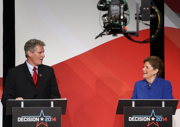 U.S. Sen. Jeanne Shaheen, right, and her Republican challenger, Scott Brown talk during a live televised debate, Tuesday, in Concord, N.H. (AP Photo/Concord Monitor, Geoff Forester, Pool)