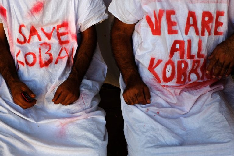 Kurdish protesters wearing an apron calling for support to save the Syrian town of Kobani from being overrun by Islamic State group fighters during a demonstration outside the Parliament of Cyprus in the capital Nicosia on Tuesday, Oct. 7, 2014. Kurdish protesters gathering outside of the parliament to call for help for the town of Kobani on the Syrian-Turkish border. (AP Photo/Petros Karadjias)