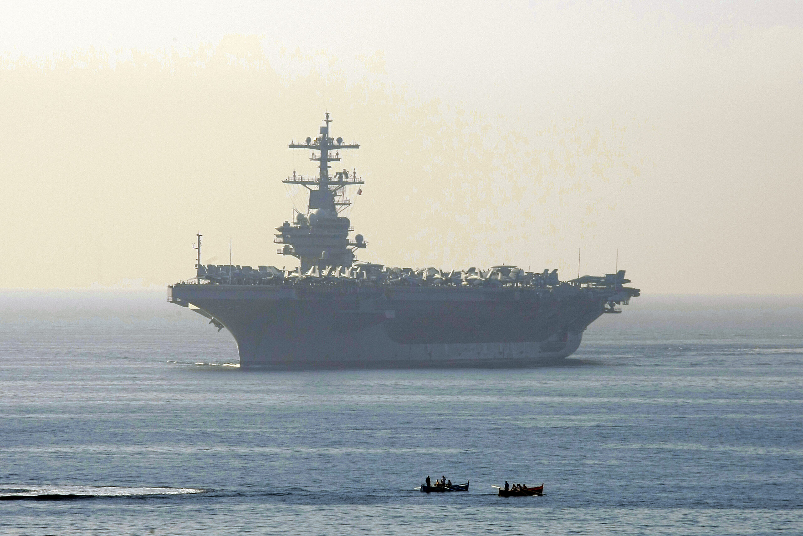 Iranian boats pointing weapons at US Navy ships, admiral says