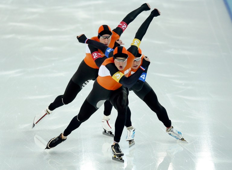 Speedskaters from team Netherlands, from top to bottom, Jan Blokhuijsen, Koen Verweij and Sven Kramer compete in the men's speedskating team pursuit quarterfinals at the Adler Arena Skating Center during the 2014 Winter Olympics in Sochi, Russia, Friday, Feb. 21, 2014.  (AP Photo/Pavel Golovkin)