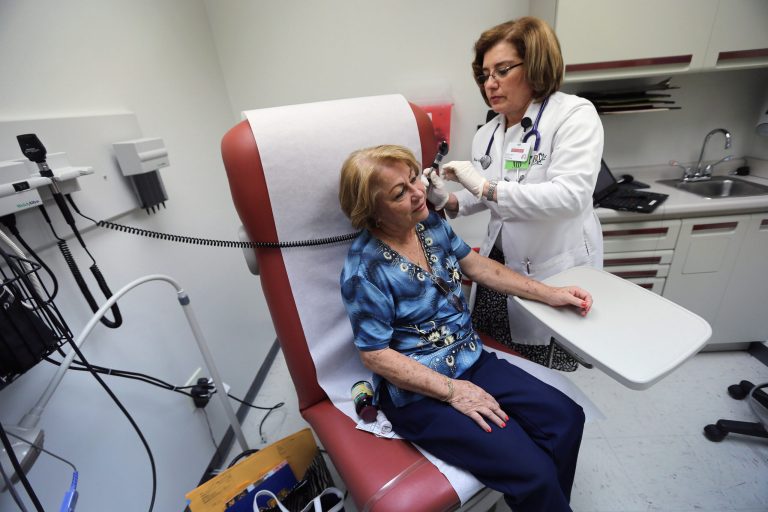 Dr. Martha Perez examines Maria Lebron in a room at the Community Health of South Florida, Doris Ison Health Center on February 21, 2013 in Miami, Fla. (Photo by Joe Raedle/Getty Images)