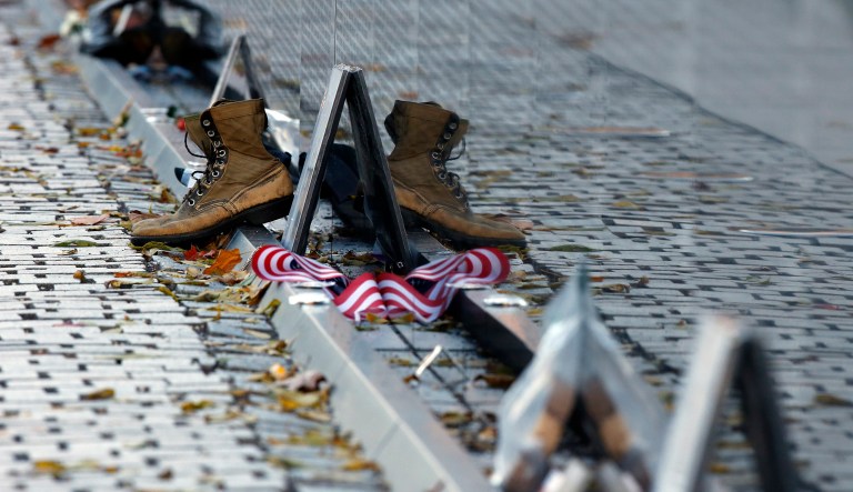 Mementos, including a worn pair of boots, have been replaced after the wall was cleaned at the Vietnam Veterans Memorial on Veterans Day, Saturday, Nov. 11, 2017, in Washington.