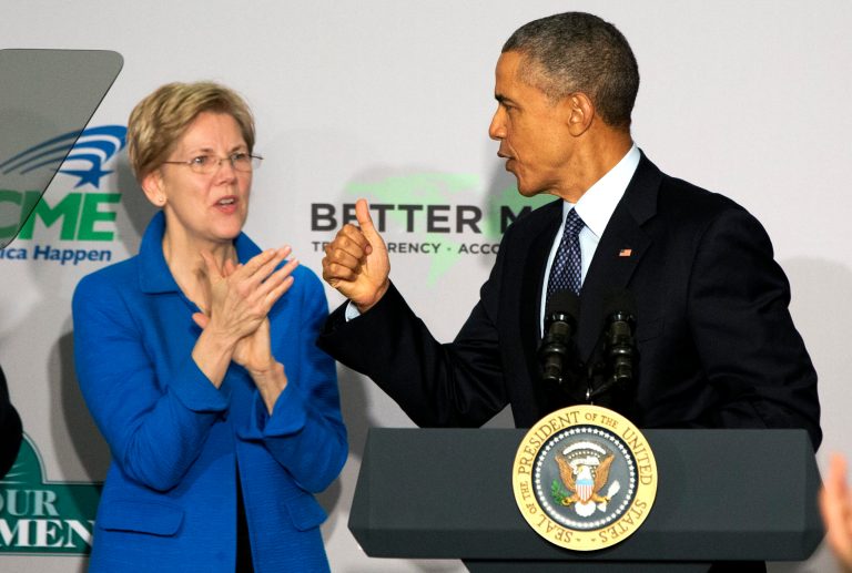 Sen. Elizabeth Warren, D-Mass. applauds as President Barack Obama makes the thumbs up sign as he arrives to speak at AARP in Washington, Monday, Feb. 23, 2015. (AP Photo/Jacquelyn Martin)