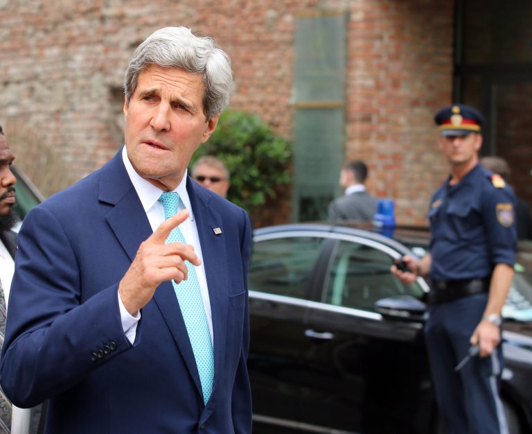 U.S. Secretary of State John Kerry gestures as he arrives in front of a hotel where closed-door nuclear talks on Iran take place in Vienna, Austria, Sunday, July 13, 2014. Kerry and fellow foreign ministers are adding their diplomatic muscle to nuclear talks with Iran, with a target date only a week away for a pact meant to curb programs Tehran could turn to making atomic arms. (AP Photo/Ronald Zak)