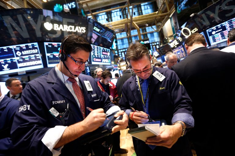 Traders Thomas Donato, left, and Ronald Madarasz work on the floor of the New York Stock Exchange on Jan. 24. The Dow Jones industrial average dropped 318 points, nearly 2 percent, to close at 15,879 Friday, its worst drop since last June. (AP Photo/Jason DeCrow)