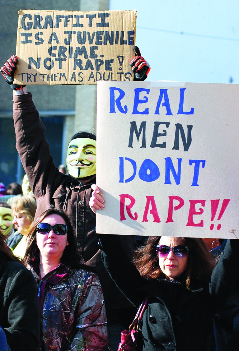 Activists from the online group KnightSec and Anonymous protest at the Jefferson County Courthouse in Steubenville, Ohio, Saturday, Jan. 5, 2013. Members of the group said they are outraged over what they contend is a cover-up in a case involving the alleged rape of a teenage girl by Steubenville High School student-athletes that reportedly occurred in 2012. (AP Photo/Steubenville Herald-Star, Michael D. McElwain)