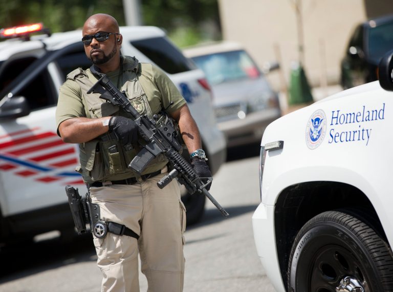 A US Marshal takes his position outside the federal court in Washington before the vehicles reportedly transporting the Libyan militant Ahmed Abu Khattala leave following Khattala's detention hearing, Wednesday, July 2, 2014.  (AP Photo/Pablo Martinez Monsivais)