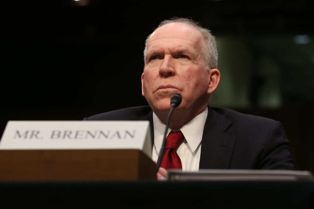 CIA Director John Brennan is the man in the middle, and it's clearly an uncomfortable position. (Graeme Jennings/Examiner)