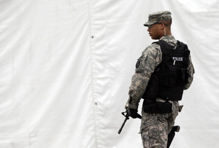 A military police officer stands guard outside of a courthouse in Fort Meade, Md., Monday, June 3, 2013, on the first day of Army Pfc. Bradley Manning's court martial. Manning, who was arrested three years ago, is charged with indirectly aiding the enemy by sending troves of classified material to WikiLeaks. He faces up to life in prison. (AP Photo/Patrick Semansky)