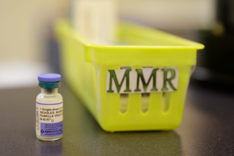 A measles vaccine is shown on a countertop.