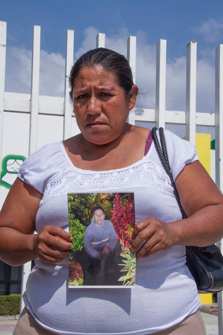 Roselia Rios Cueto, holds up a photo of her son, Ezequiel Cordoba Rios in Tuxtla Gutierrez, Mexico, Thursday Feb. 6, 2014. Cordoba was the Mexican fisherman who died during a reported 13-month sea odyssey with Jose Salvador Alvarenga. Alvarenga, a Salvadoran fisherman, said Cordoba died early in the voyage and that he tossed Cordoba body overboard, while he survived by eating fish, turtles and birds. (AP Photo/Moyses Zuniga)
