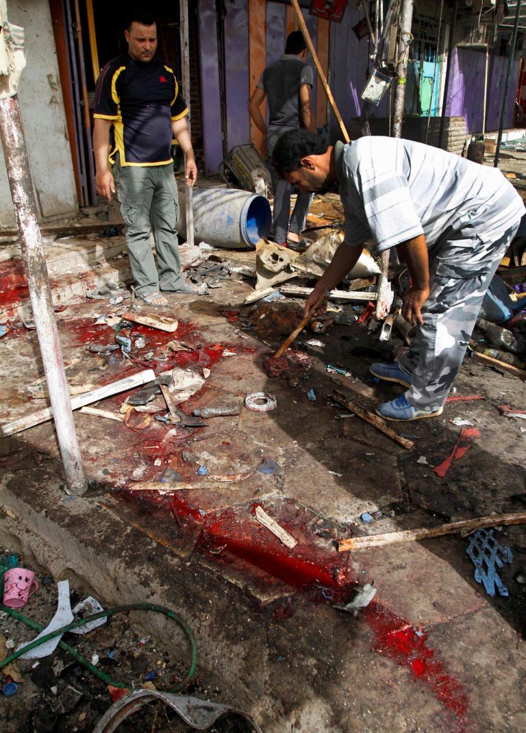 Civilians inspect the site of a car bomb attack in front of a crowded popular restaurant in Basra, 340 miles (550 kilometers) southeast of Baghdad, Iraq, Monday, May 20, 2013. Two car bombings in the southern city of Basra, killing and wounding dozens of people, police said. Iraq has seen a spike of attacks, including bombings hitting both Sunni and Shiite civilian targets over the last week. (AP Photo/ Nabil al-Jurani)