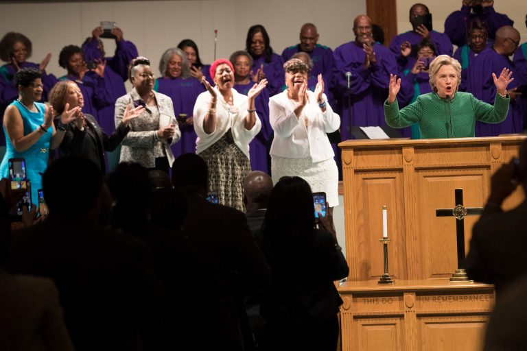 Democratic presidential candidate Hillary Clinton is joined by mothers of black men who died from gun violence, Geneva Reed-Veal, left, mother of Sandra Bland, Lucia McBath, second from left, mother of Jordan Davis, Sybrina Fulton, center, mother of Trayvon Martin, Maria Hamilton, second from right, mother of Dontre Hamilton, and Gwen Carr, mother of Eric Garner as she speaks during Sunday service at Union Baptist church, Sunday, Oct. 23, 2016, in Durham, N.C. (AP Photo/Mary Altaffer)