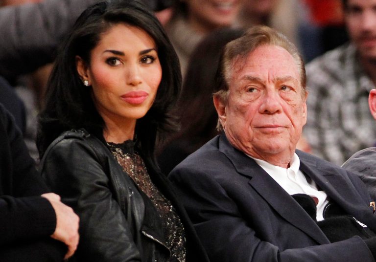 Los Angeles Clippers owner Donald Sterling, right, and V. Stiviano, left, watch the Clippers play the Los Angeles Lakers during an NBA preseason basketball game in Los Angeles. (AP Photo/Danny Moloshok, File)