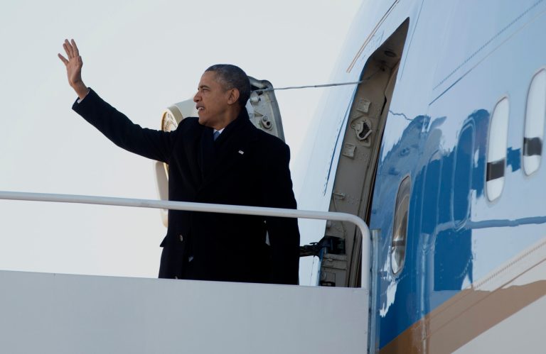 President Obama boarded Air Force One this morning together with the 949-page, $956 billion farm bill, which he plans to sign at the Michigan State University on Friday. (AP Photo)