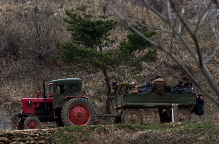 In this April 23, 2013 photo, North Korean farmers ride in the back of a tractor drawn wagon near Kaesong, North Korea. Farmers in North Korea have confirmed that they have begun carrying out new economic policies designed to boost productivity by giving managers and workers financial incentives. Some foreign analysts say the moves are reminiscent of early reform in China in the late 1970s. (AP Photo/David Guttenfelder)