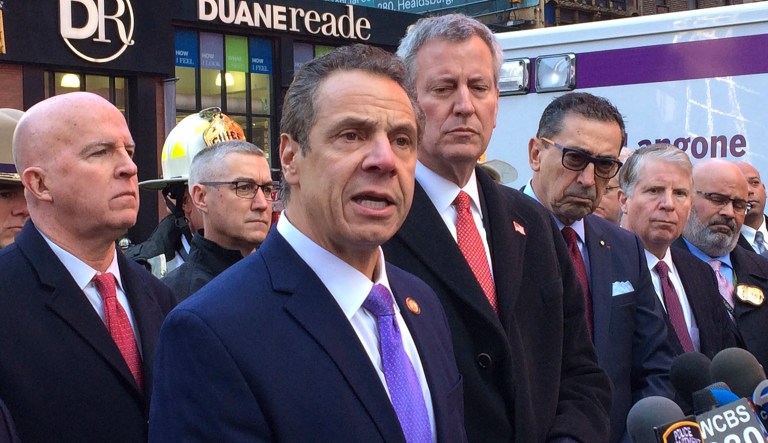 New York Gov. Andrew Cuomo speaks to members of the media after a pipe bomb strapped to a man went off in a New York City subway near Times Square on Monday in New York. Mayor Bill de Blasio stands fourth from left. (AP Photo/Mark Lennihan)