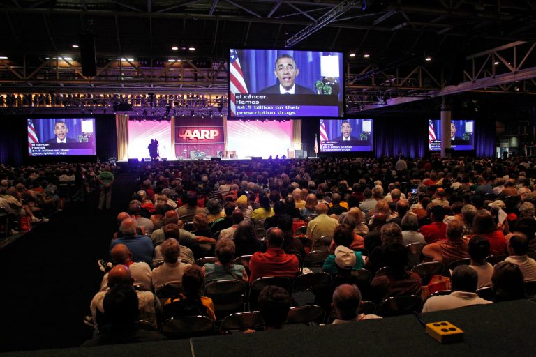President Barack Obama addresses the AARP convention via satellite. (AP Photo)