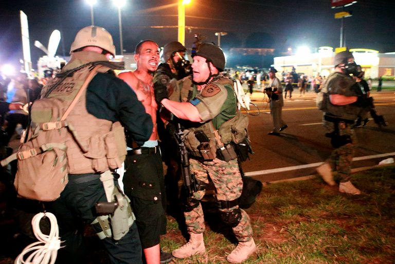 A protestor is detained Monday, in Ferguson, Mo. The Aug. 9 shooting of Michael Brown by police has touched off rancorous protests in Ferguson, a St. Louis suburb where police have used riot gear and tear gas. (AP Photo/St. Louis Post-Dispatch, Christian Gooden)
