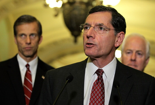 WASHINGTON, DC - DECEMBER 11:  U.S. Sen. John Barrasso (R-WY) (C) speaks as Sen. John Thune (R-SC) (L) and Sen. John Cornyn (R-TX) (R) listen during a news briefing after the weekly Senate Republican Policy Luncheon December 11, 2012 on Capitol Hill in Washington, DC. McConnell discussed various topics with the media including the fiscal cliff issue saying 