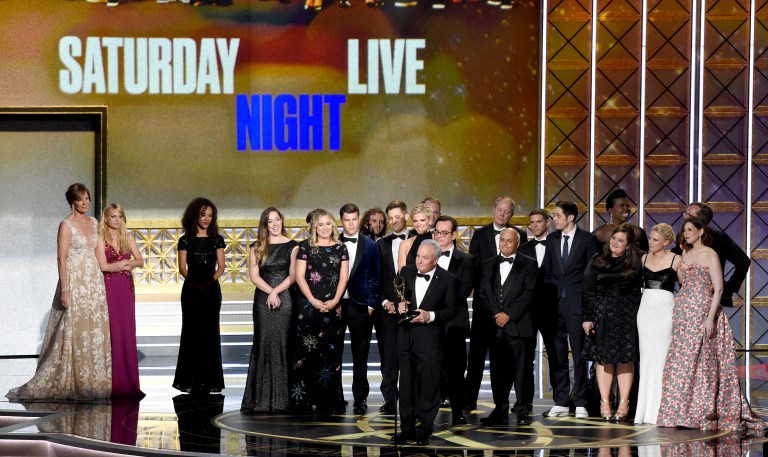 "SNL" creator and executive producer Lorne Michaels, above with the cast of the show, accepts the award for outstanding variety sketch series for "Saturday Night Live" at the 69th Primetime Emmy Awards. It's unclear whether the cast will address the Weinstein controversy tonight. The show did not last week.