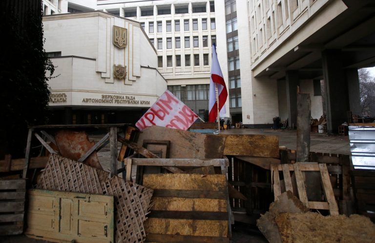 Barricades in front of local government building with banner which reeds: 'Crimea Russia