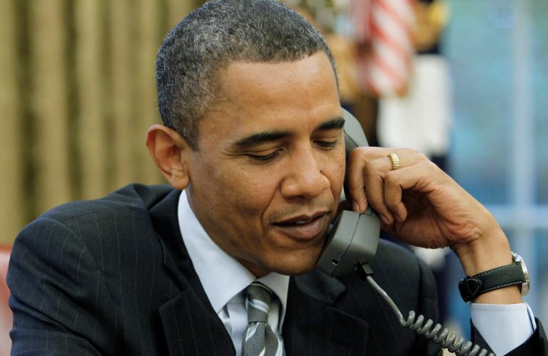 FILE - This May 11, 2010 file photo by an Associated Press photographer shows President Barack Obama talking on the phone with British Prime Minister David Cameron, in the Oval Office of the White House in Washington. Twice from 2008-2013, White House-based photographers have been given access to President Obama working at his desk alone in the Oval Office. (AP Photo/Charles Dharapak, File)
