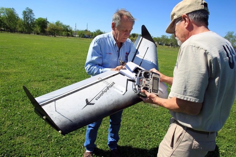 In this photo taken on April 8, 2014, Tim Miller, left, Texas EquuSearch founder, and volunteer Gene Robinson, who builds the group's drones, checks out the wiring of a drone they have used for searches in Santa Fe, Texas. The group relies mostly on horseback and all-terrain vehicles to search rough terrain. But it also employs 4-pound aerial drones to survey the ground with digital cameras. (AP Photo/Houston Chronicle, Mayra Beltran)ÃÂ 