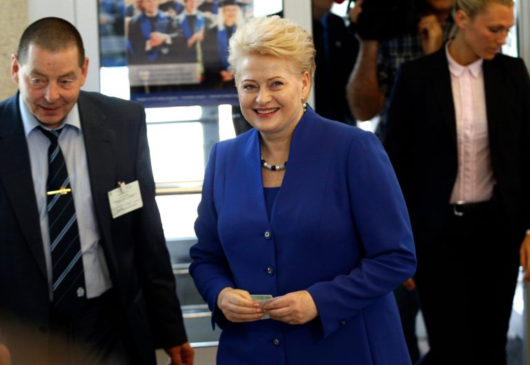 Lithuania's President Dalia Grybauskaite and presidential candidate, arrives at a polling station during the second round of voting in presidential elections in Vilnius, Lithuania, Monday, May 25, 2014. Polls have opened in Lithuania for the second round of the presidential election, in which incumbent Grybauskaite is competing against the center-left candidate Zigmantas Balcytis. (AP Photo/Mindaugas Kulbis)