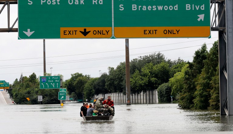Residents are rescued from their homes surrounded by floodwaters from Tropical Storm Harvey on Sunday, Aug. 27, 2017, in Houston, Texas. (AP Photo/David J. Phillip)
