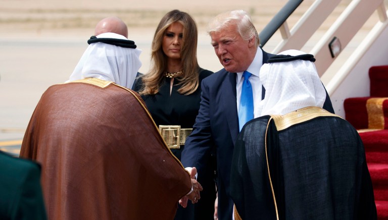 President Trump, top right, accompanied by first lady Melania Trump, center, shakes hands with Saudi King Salman during a welcome ceremony at the Royal Terminal of King Khalid International Airport in Riyadh. (AP Photo/Evan Vucci)