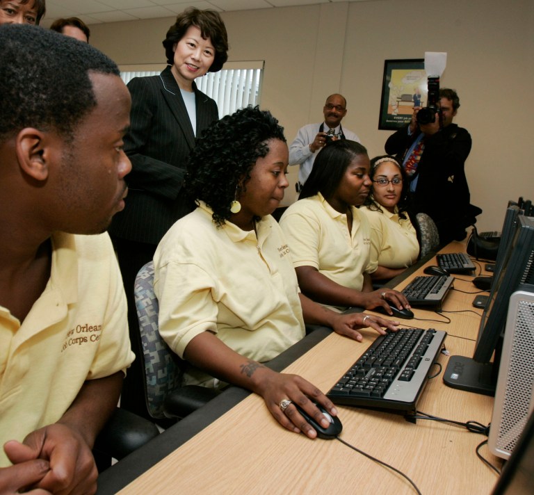 Then-U.S. Secretary of Labor Elaine L. Chao watches students work on computers at the New Orleans Job Corps Center in New Orleans, Tuesday, Aug. 21, 2007. (AP Photo/Bill Haber)