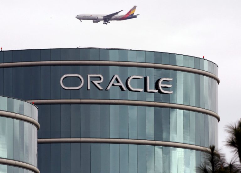   FILE - In this Tuesday, March 20, 2012, file photo, a plane flies over Oracle headquarters in Redwood City, Calif. Oracle's latest quarterly earnings rose 18 percent as companies splurged on more software and other technology toward the end of the year. (AP Photo/Paul Sakuma, File)  