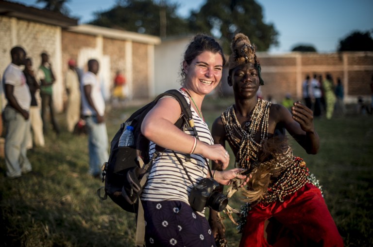 FILE - In this file photo taken Oct. 6, 2013 in the Bonga Bonga stadium in Bangui, Central African Republic, French photojournalist Camille Lepage smiles with a local dancer. Lepage, 26, was killed while covering the deteriorating situation in the Central African Republic Monday May 12, 2014. (AP Photo/Sylvain Cherkaoui, File)