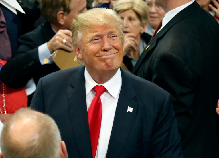 Republican presidential candidate Donald Trump smiles for news photographers as he takes a break from greeting supporters at rally in Biloxi, Miss., Saturday, Jan. 2, 2016. (AP Photo/Rogelio V. Solis)