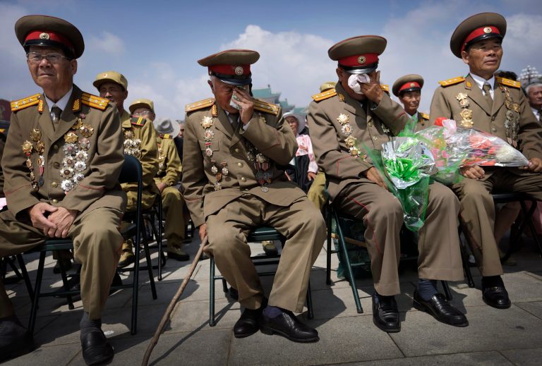 North Korean war veterans express varying degrees of emotion as they watch a parade celebrating the anniversary of the Korean War, Sunday, July 27, 2014, in Pyongyang, North Korea. North Koreans gathered at Kim Il Sung Square as part of celebrations for the 61st anniversary of the armistice that ended the Korean War. (AP Photo/Wong Maye-E)