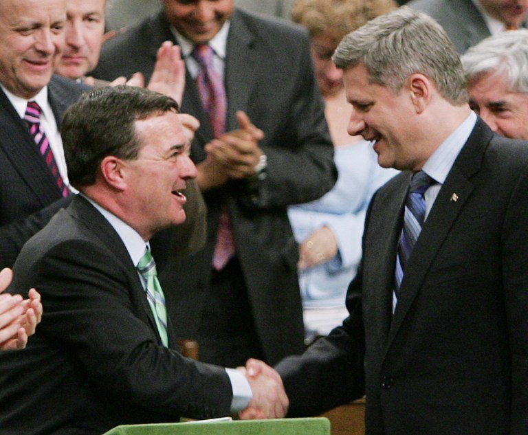 File-This May 2, 2006, file photo shows then Finance Minister Jim Flaherty shaking hands with Prime Minister Stephen Harper as he tables the Budget in the House of Commons on Parliament Hill in Ottawa. Flaherty, the former finance minister who took the country from surplus to huge, recession-spawned deficits and back to within an eyelash of a surplus, died suddenly Thursday April 10, 2014. (AP Photo/The Canadian Press, Chris Wattie, File)