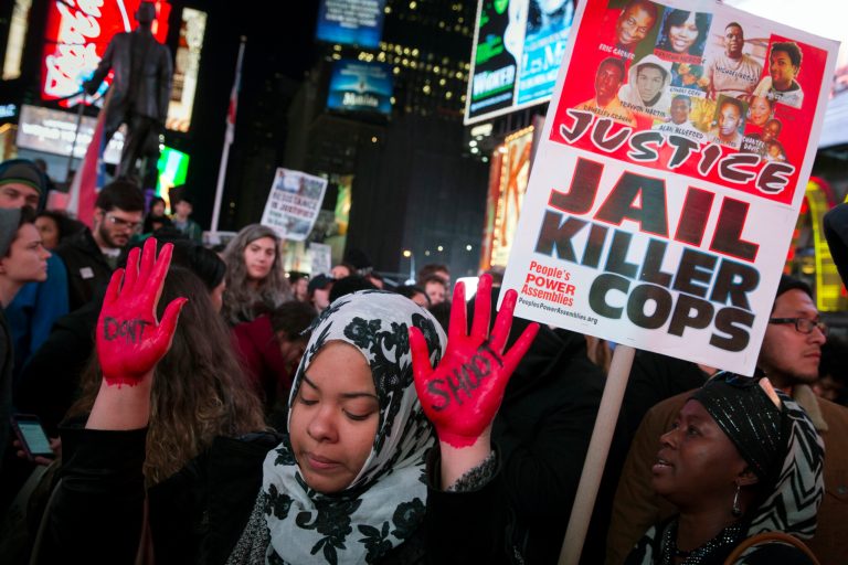 In this Nov. 25, 2014 file photo, demonstrator Maryam Said raises her painted hands during a protest against a grand jury's decision on Monday not to indict Ferguson police officer Darren Wilson in the shooting of Michael Brown in New York. (AP Photo/John Minchillo, File)