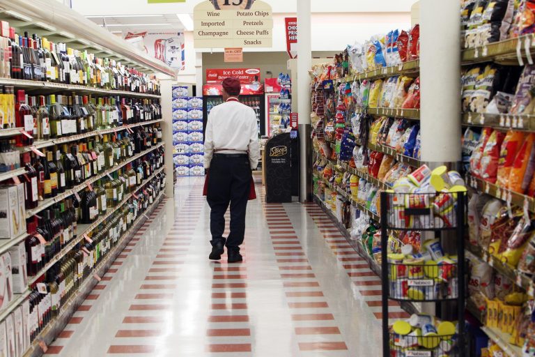 An employee of the Market Basket supermarket chain walks down an empty isle Thursday July 24, 2014, in Concord, N.H. (AP Photo)