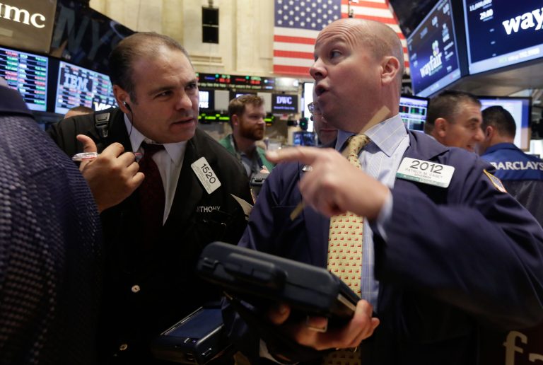 Traders Anthony Riccio, left, and Patrick Casey work on the floor of the New York Stock Exchange, Thursday, Oct. 2, 2014. U.S. markets were mostly flat in early trading Thursday, follow a sell-off the day before, as U.S. investors had little reaction to comments from European Central Bank President Mario Draghi, who announced new economic stimulus measures for the continent. (AP Photo/Richard Drew)