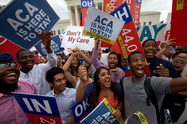 Students cheer as they hold up signs supporting the Affordable Care Act (ACA) after the Supreme Court decided that the ACA may provide nationwide tax subsidies, Thursday June 25, 2015. (AP)