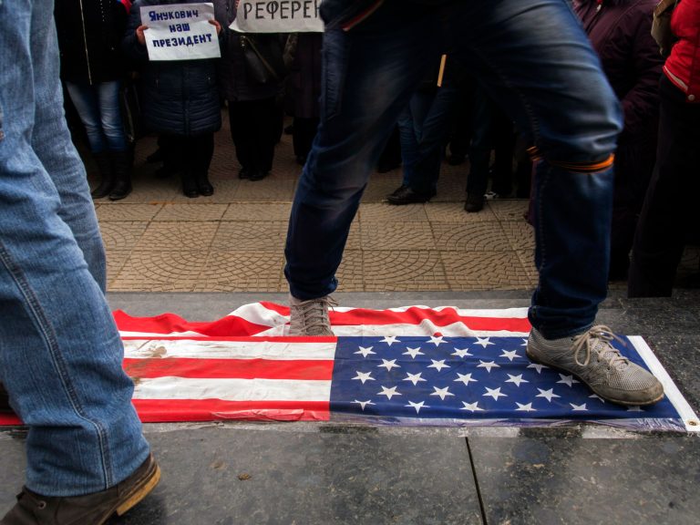 Demonstrators trample a U.S. flag during an anti-government rally in Luhansk, Ukraine, on March 29.  (AP Photo/Igor Golovniov)