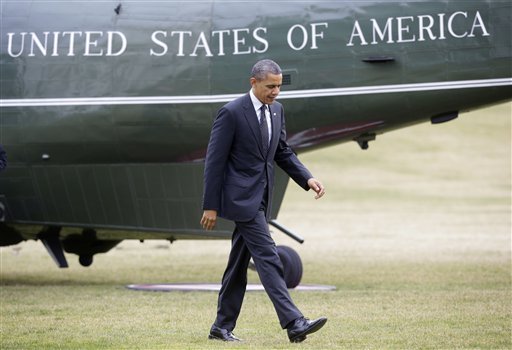 President Barack Obama walks across the South Lawn of the White House in Washington, Thursday, Feb. 7, 2013, following his arrival on Marine One helicopter from the House Democratic Issues Conference in Lansdowne, Va. (AP Photo/Pablo Martinez Monsivais)